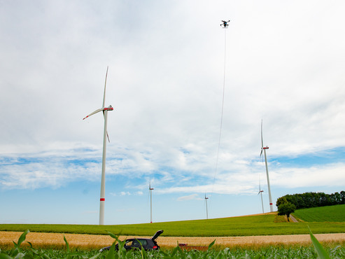 A tethered drone is operated in a windpark